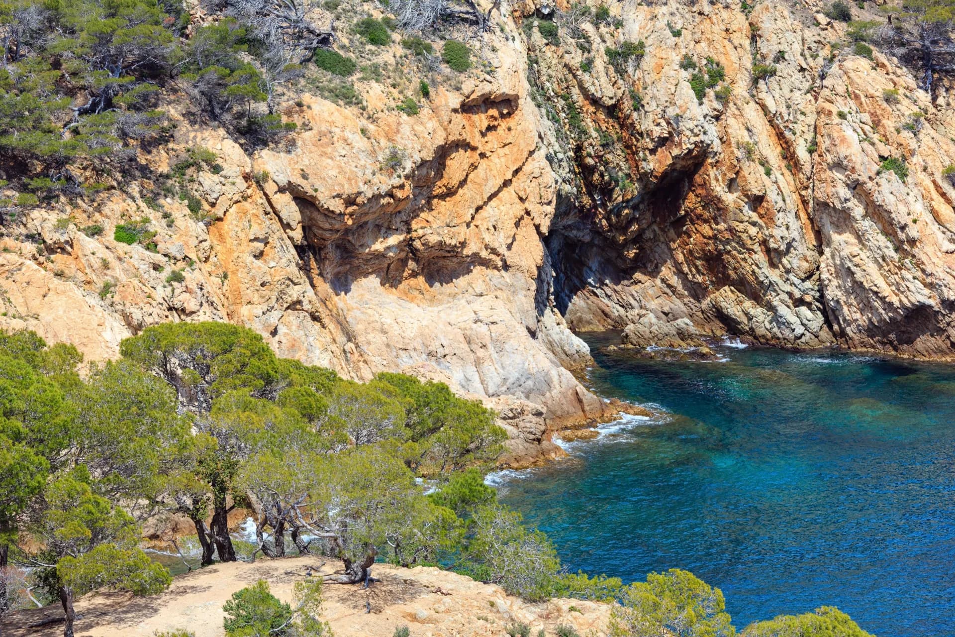 Crique rocheuse aux eaux turquoise bordée de falaises escarpées à Majorque
